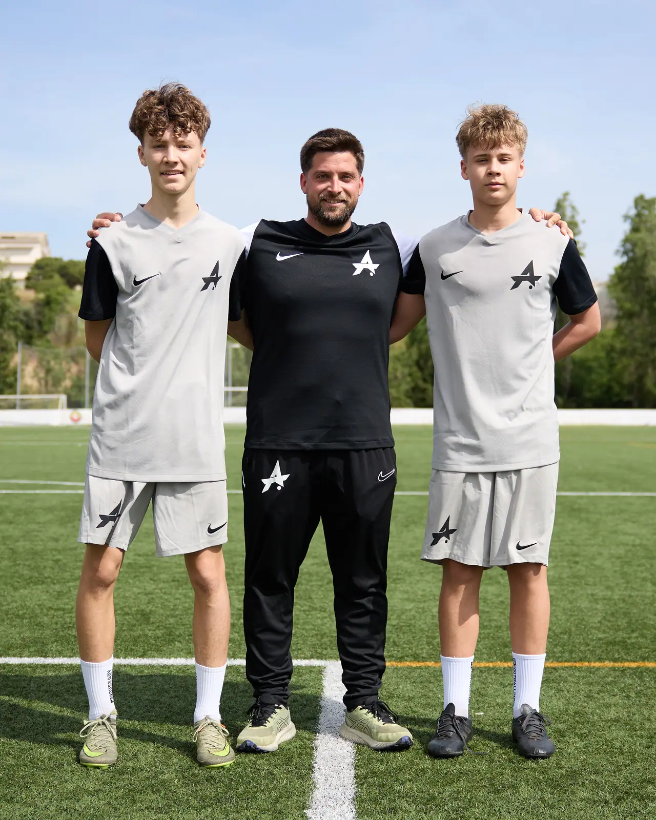 ATG coach with two players on the pitch